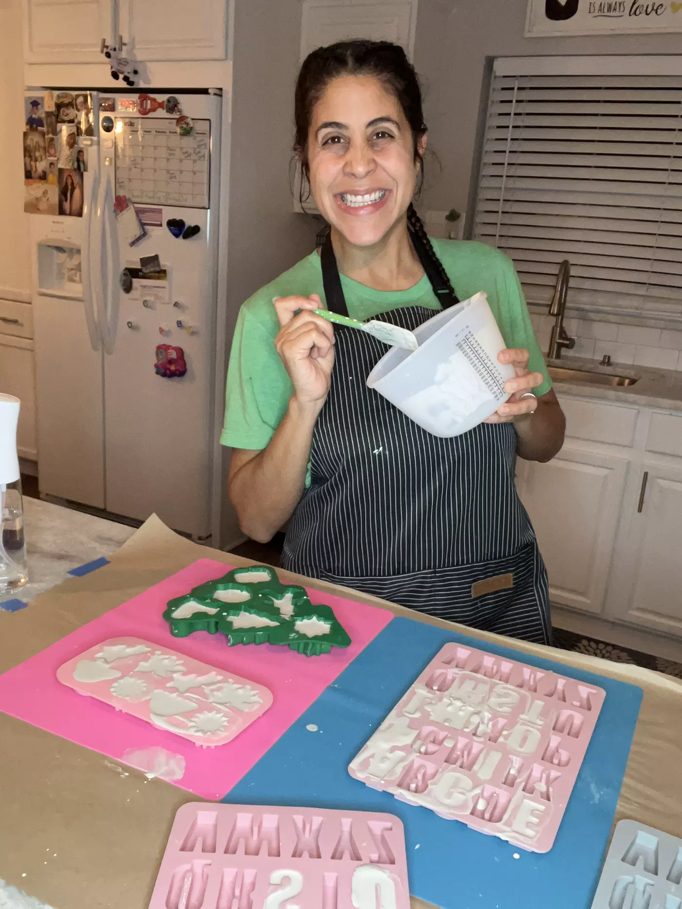 Venus pouring plaster at the Familia Ibarra Craft Co work table